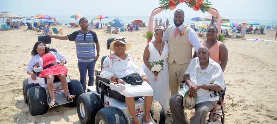 Family rents two beach wheelchairs to attend a wedding